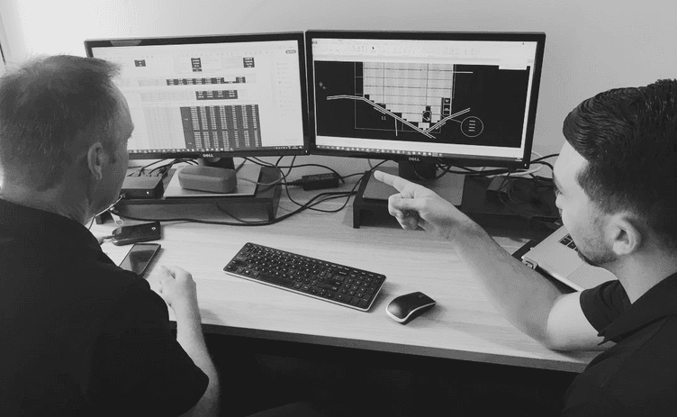 Two men in front of computer screen